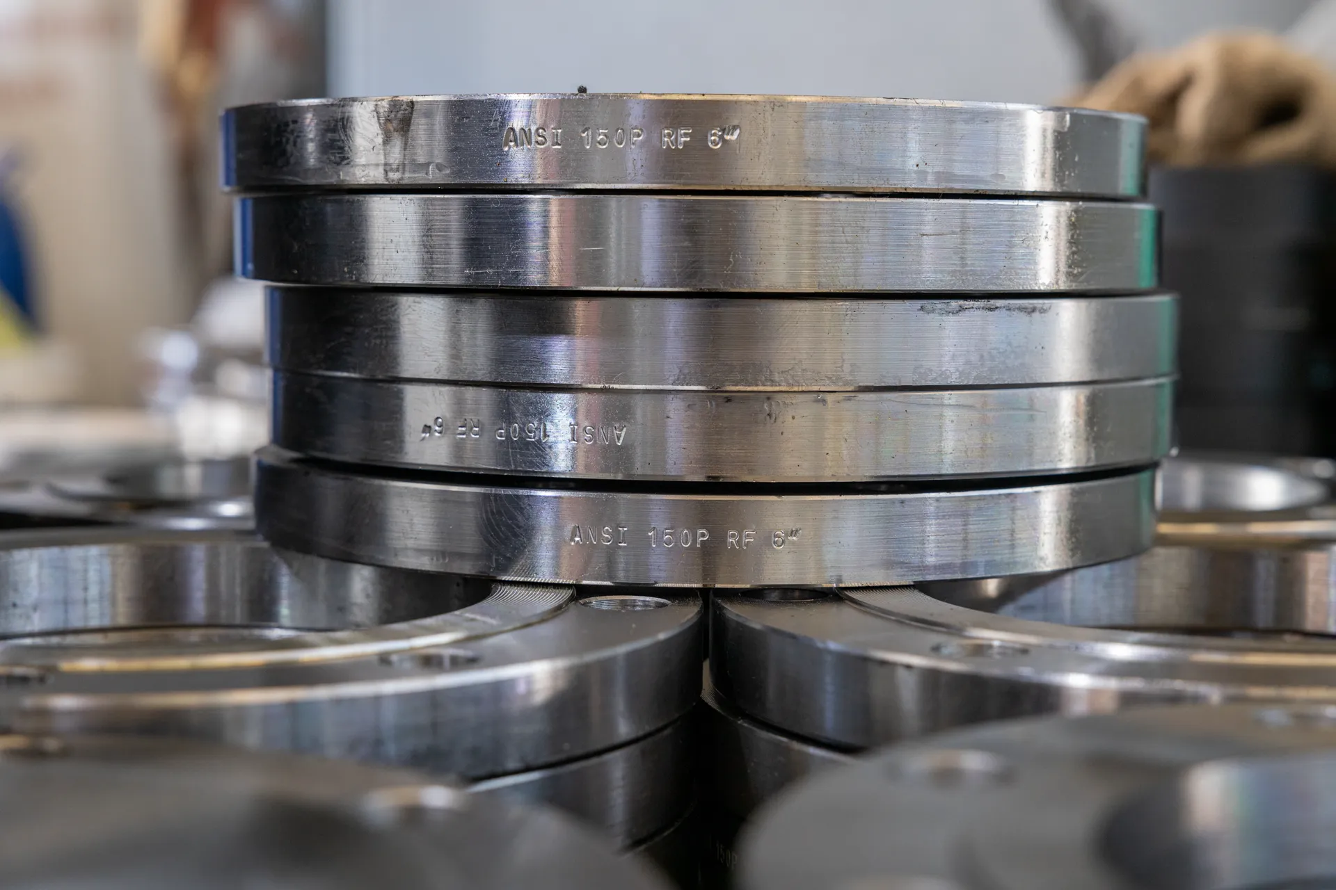 Stacked metal flanges — industrial workshop